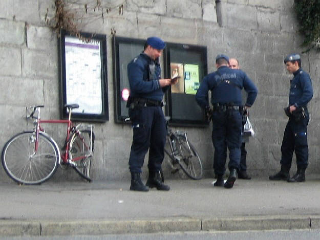 zurich switzerland city police hassling a man at central square. stadtpolizei zürich, personenkontrolle am zürcher central.