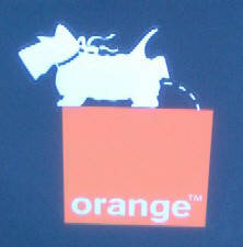 logo-busting in zurich switzerland. pissdog streetart sticker on top of orange telecom logo